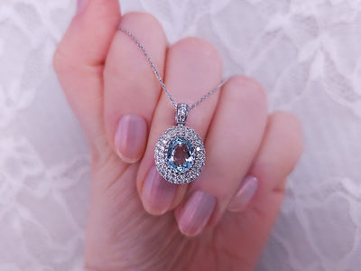 Diamond and oval aquamarine necklace in 14 K white gold