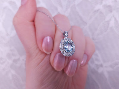 Diamond and oval aquamarine necklace in 14 K white gold