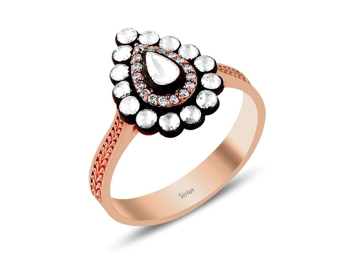 Ring with pear-shaped and round diamonds