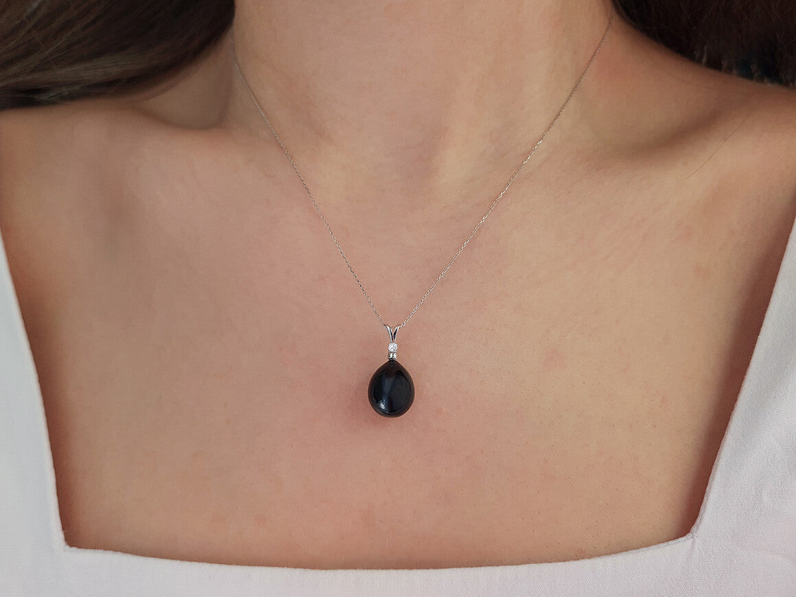 Diamond and drop black pearl necklace in 14 carat white gold