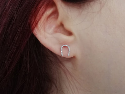 Diamond horseshoe earrings in 14 carat white gold