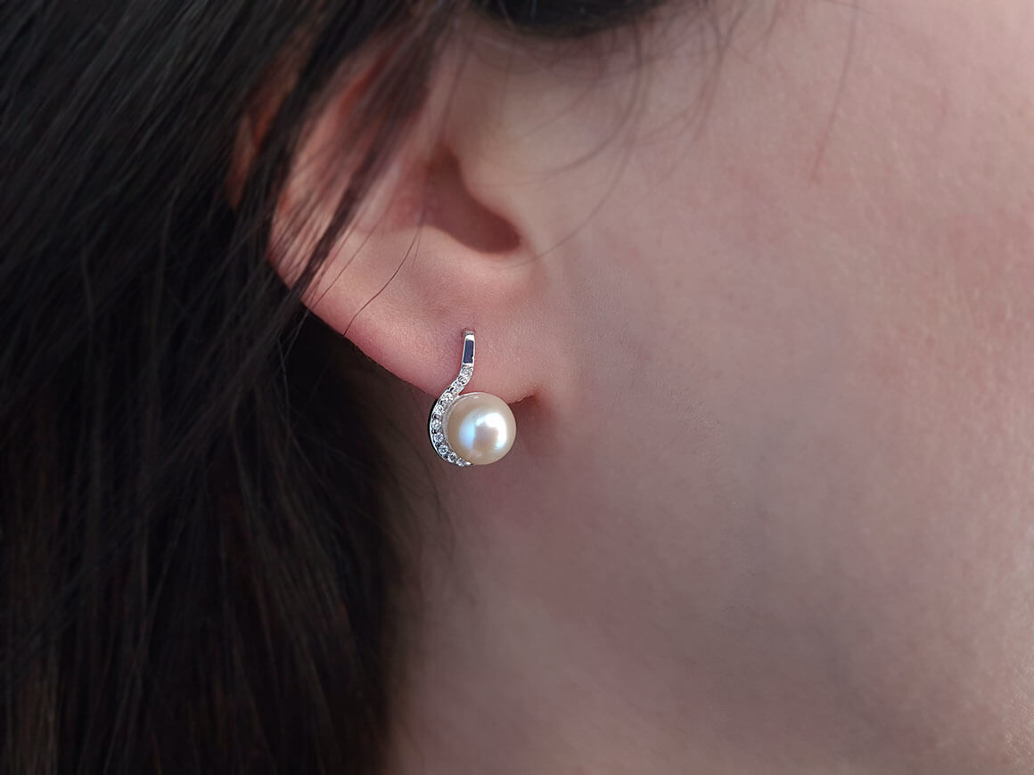 Diamond and natural pearl stud earrings in 14 carat white gold