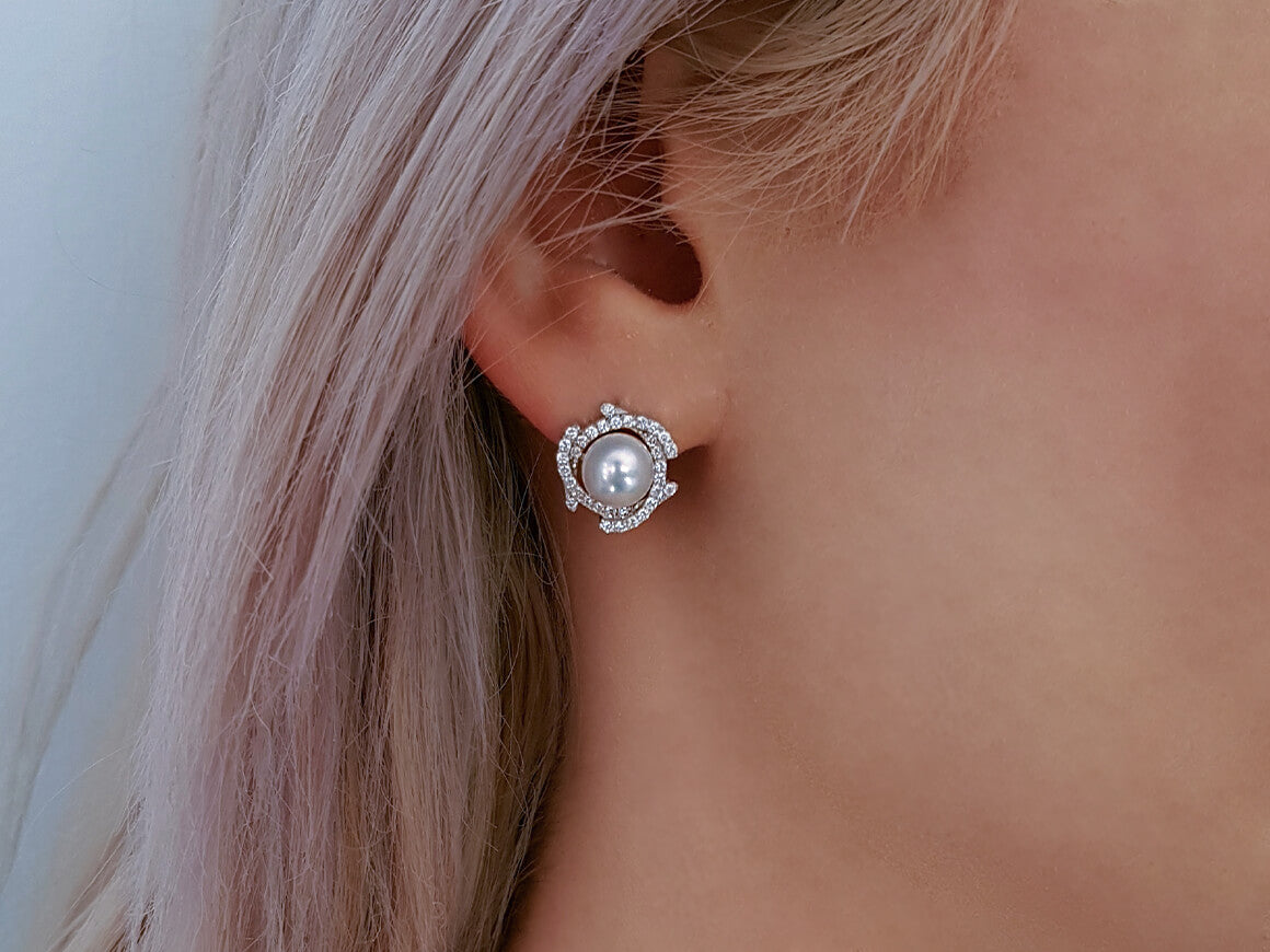 Diamond and natural pearl earrings in 14 carat white gold