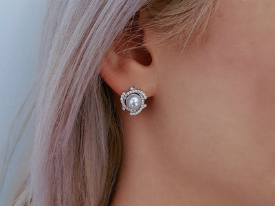 Diamond and natural pearl earrings in 14 carat white gold