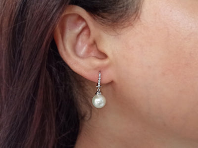 Diamond and natural pearl earrings in 14 carat white gold