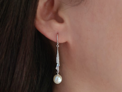 Diamond and natural pearl earrings in 14 carat white gold