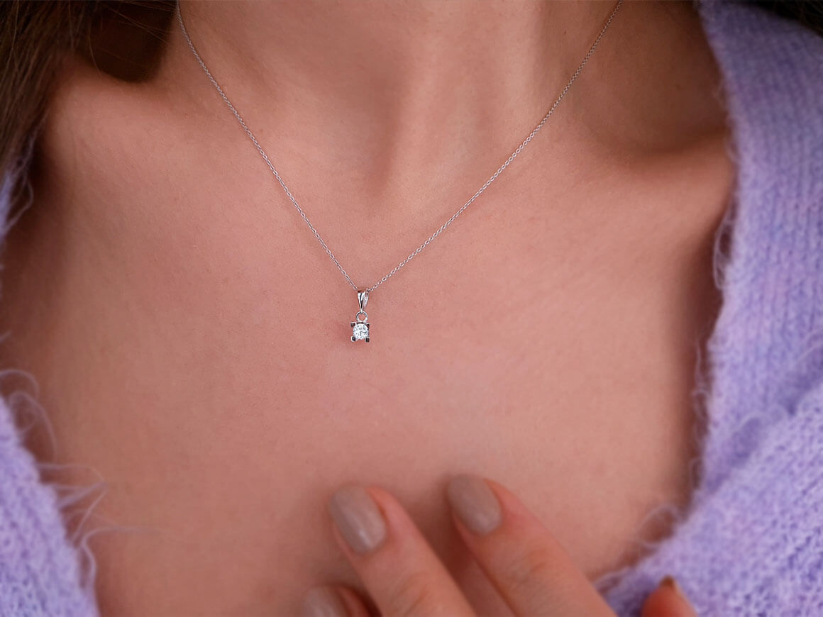 0.13 carat diamond solitaire necklace in 14 K white gold