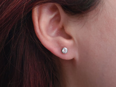 0.51 carat diamond solitaire earrings in 14 K white gold