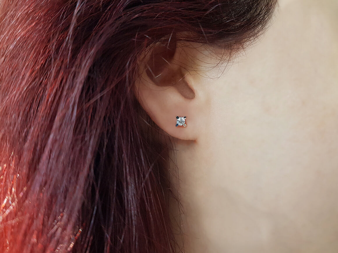 0.41 carat diamond solitaire stud earrings in 14 K white gold