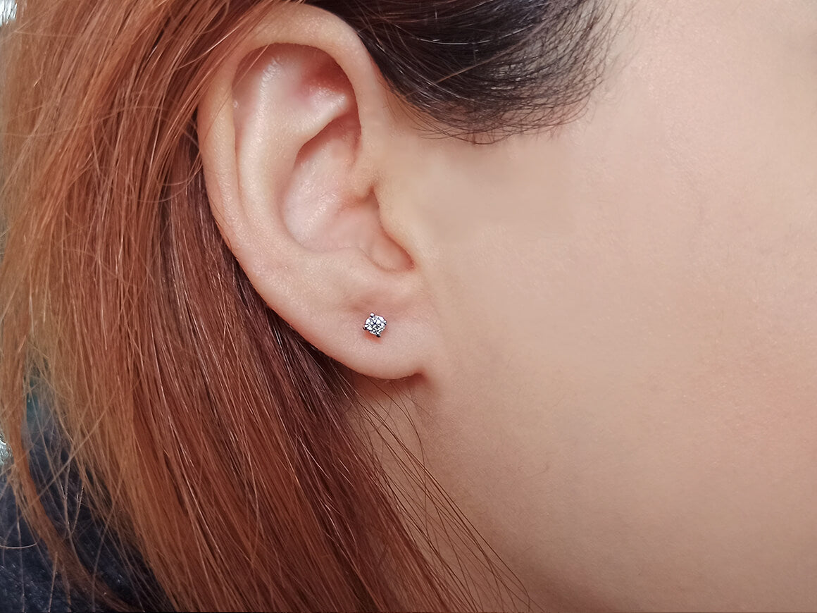 0.19 carat diamond solitaire stud earrings in 14K