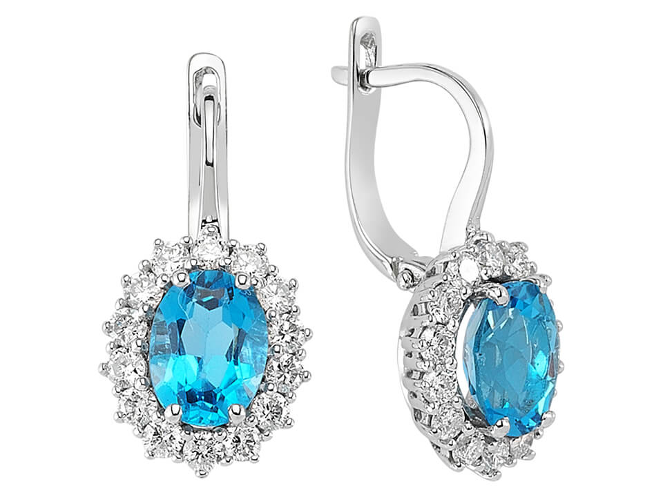 Diamond and oval cut blue topaz earrings in 14 carat white gold