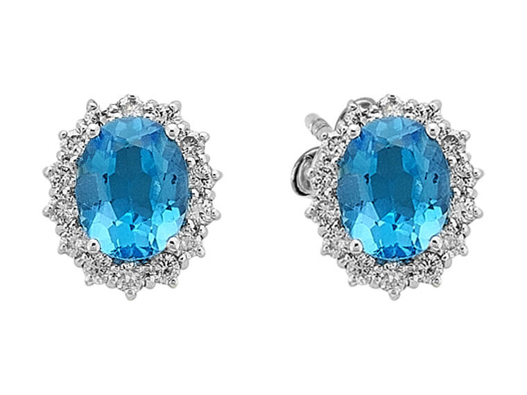 Diamond and oval blue topaz earrings in 14k white gold