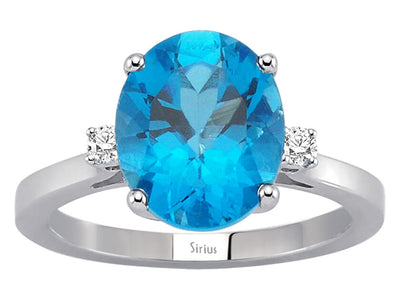 Diamond and oval blue topaz ring in 14 carat white gold
