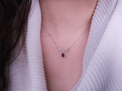 Diamond and teardrop ruby necklace in 14 K white gold