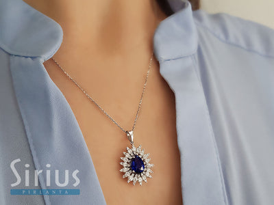 Diamond and drop sapphire necklace in 14 K white gold