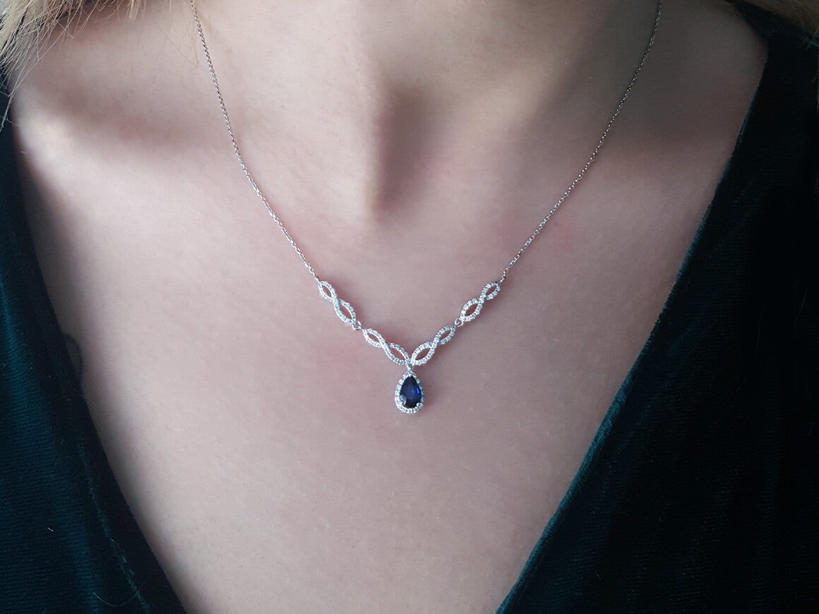 Diamond and drop sapphire necklace in 14 K white gold