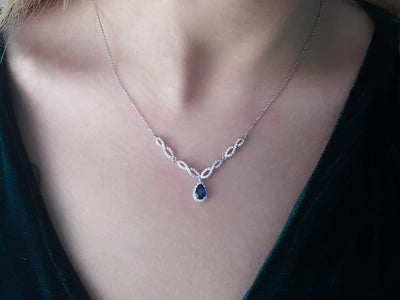Diamond and drop sapphire necklace in 14 K white gold