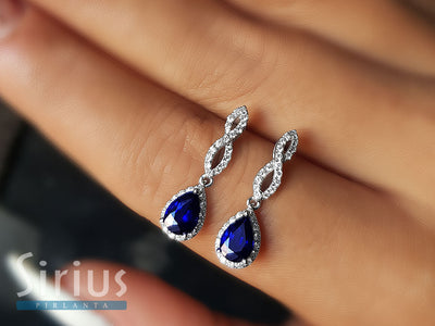 Diamond and teardrop sapphire earrings in 585 14 carat white gold