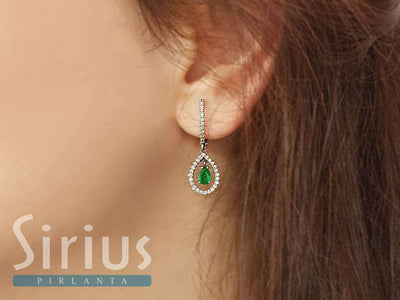 Diamond and drop emerald earrings in 14 carat white gold