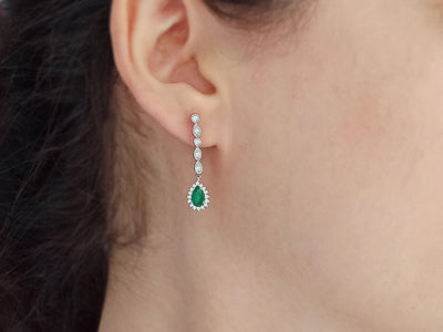 Diamond and drop emerald earrings in 14 carat white gold