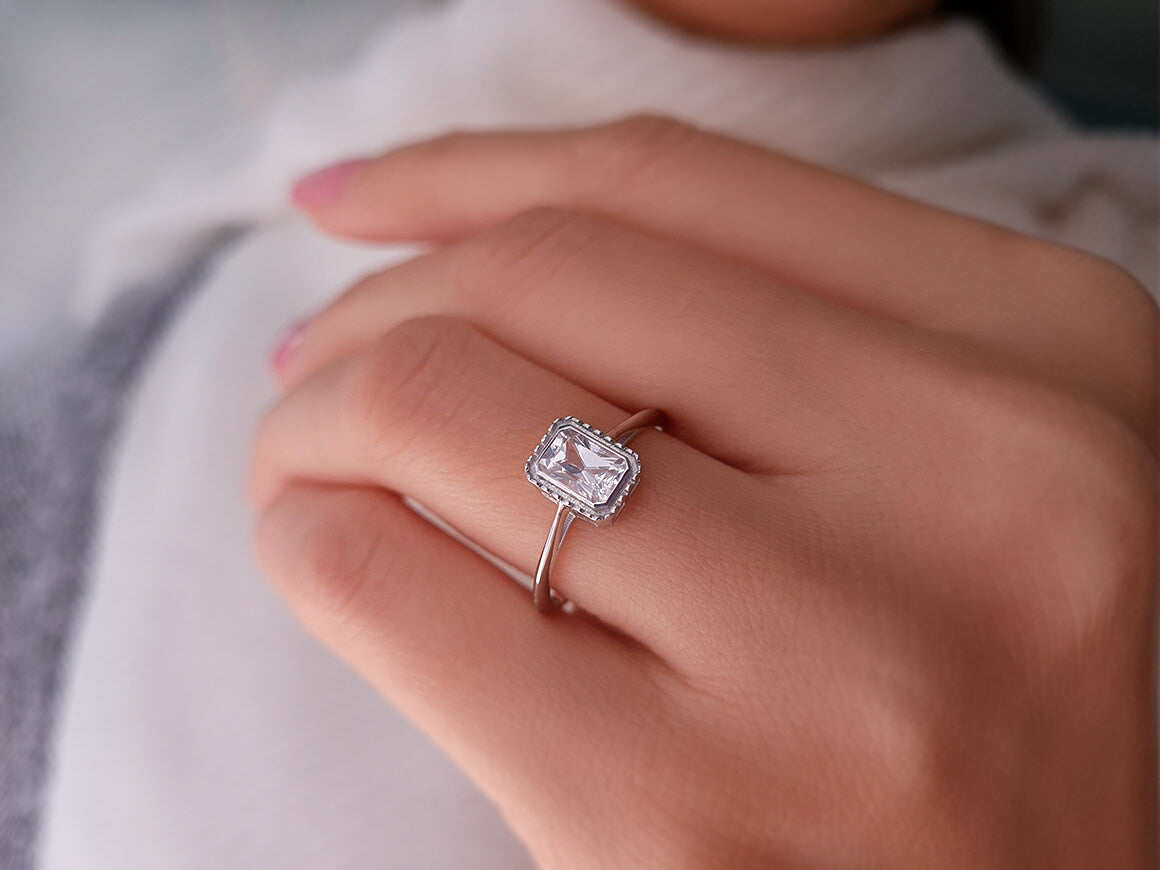 0.70 carat emerald-cut white sapphire solitaire ring in 14k white gold