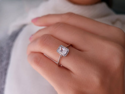 0.70 carat emerald-cut white sapphire solitaire ring in 14k white gold