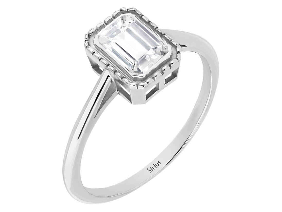 0.70 carat emerald-cut white sapphire solitaire ring in 14k white gold