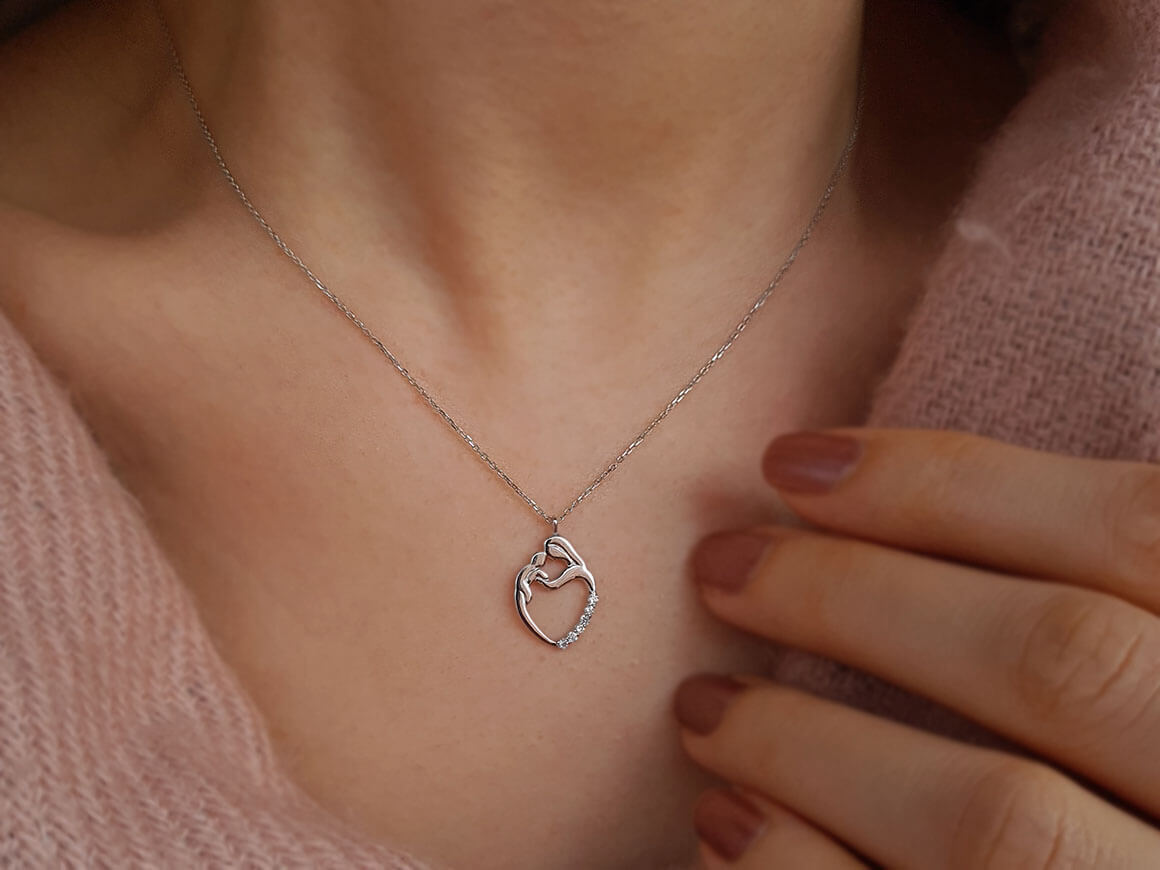 Diamond mother and child motif necklace
