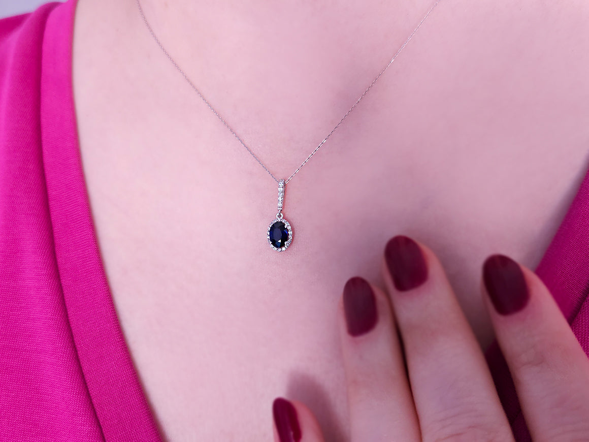 Diamond and oval sapphire necklace in 14 carat white gold