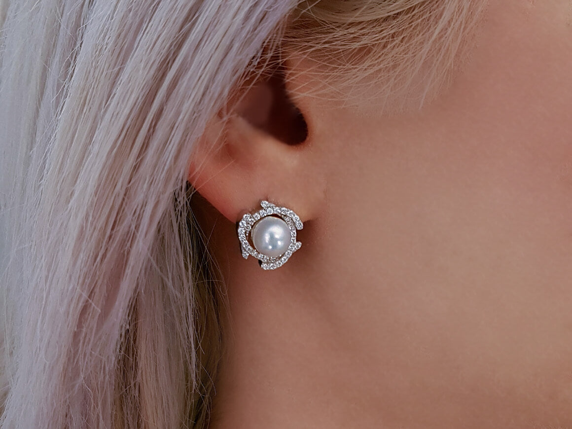Diamond and natural pearl earrings in 14 carat white gold