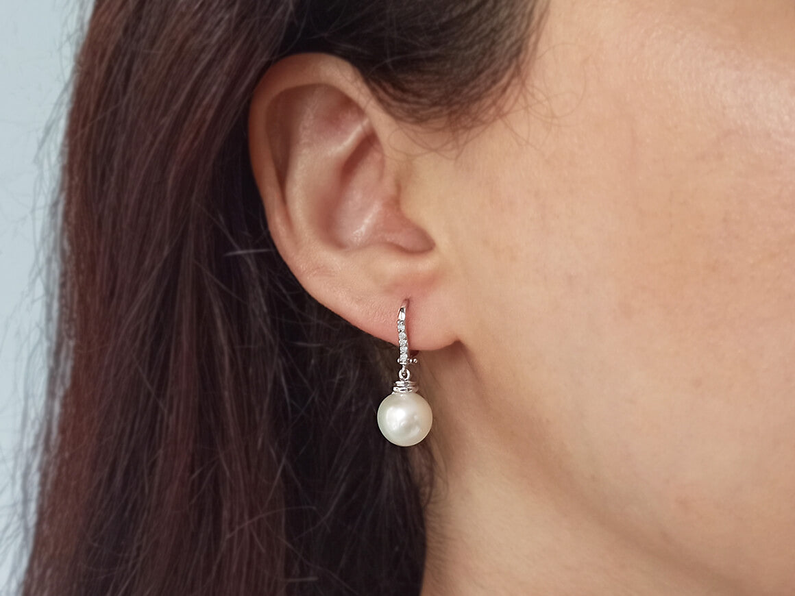 Diamond and natural pearl earrings in 14 carat white gold