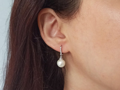 Diamond and natural pearl earrings in 14 carat white gold
