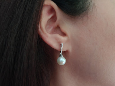 Diamond and natural pearl earrings in 14 K white gold