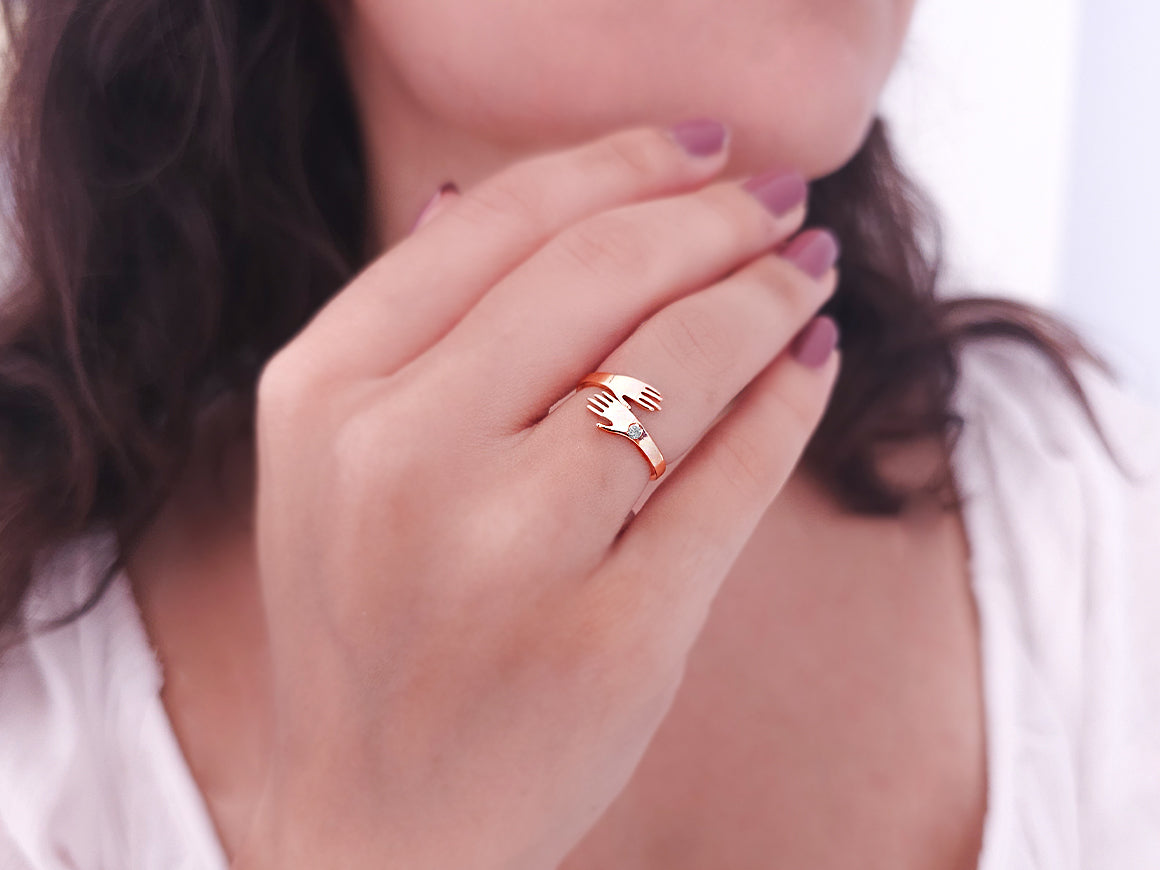 Ring with diamonds and clasped hands