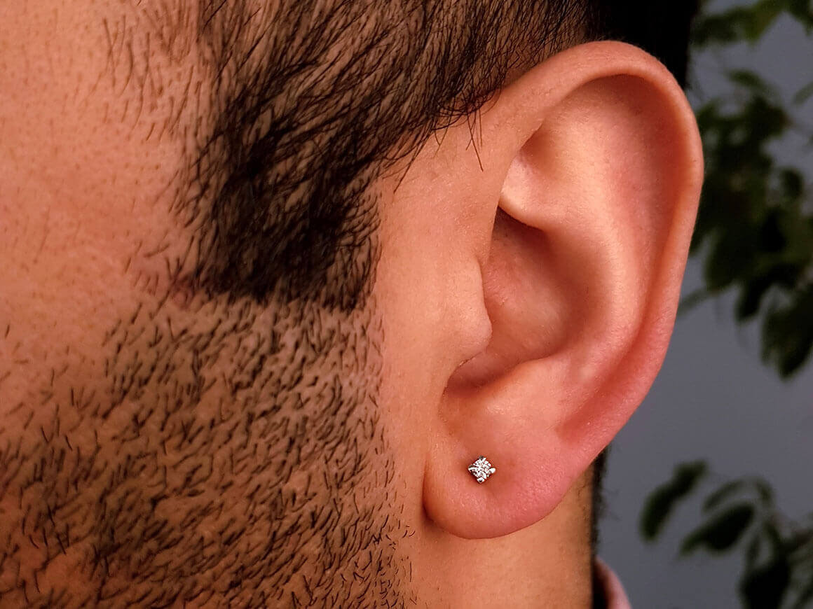 0.06 carat diamond solitaire men's stud earrings in 8 K white gold