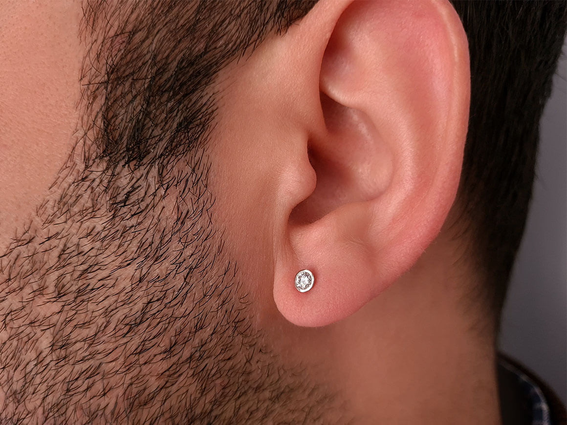 0.14 carat solitaire diamond men's earring in 14 carat white gold