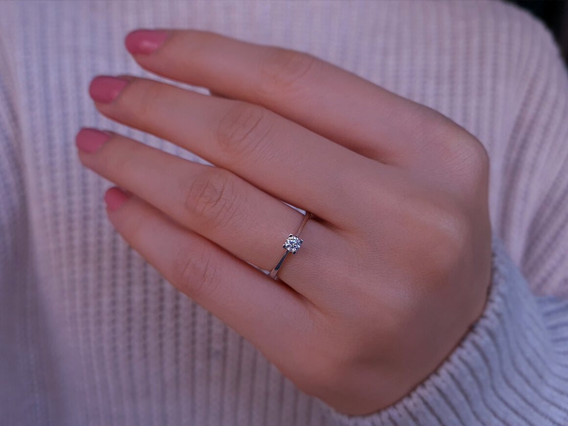 0.14 carat diamond solitaire ring in 18K white gold
