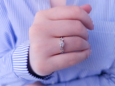 Diamond ring with white sapphire