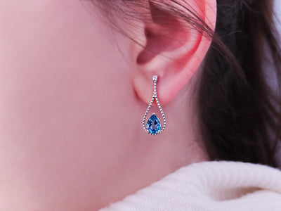 Earrings with diamonds and drop-shaped blue topazes