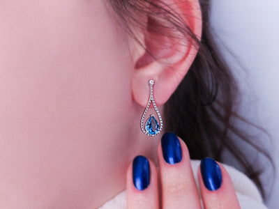 Earrings with diamonds and drop-shaped blue topazes