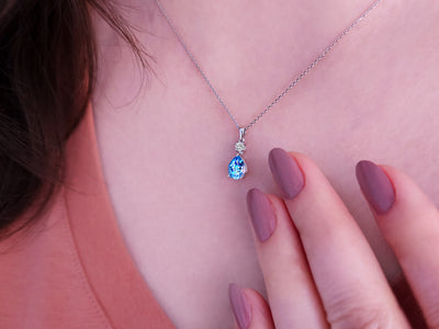 Necklace with diamonds and drop-shaped blue topazes