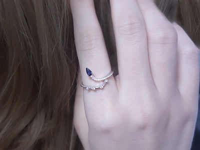 Diamond and drop sapphire swan neck ring in 8 K white gold