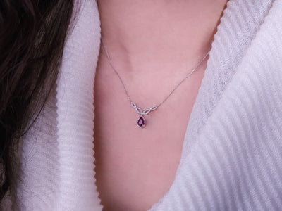 Diamond and teardrop ruby necklace in 14 K white gold