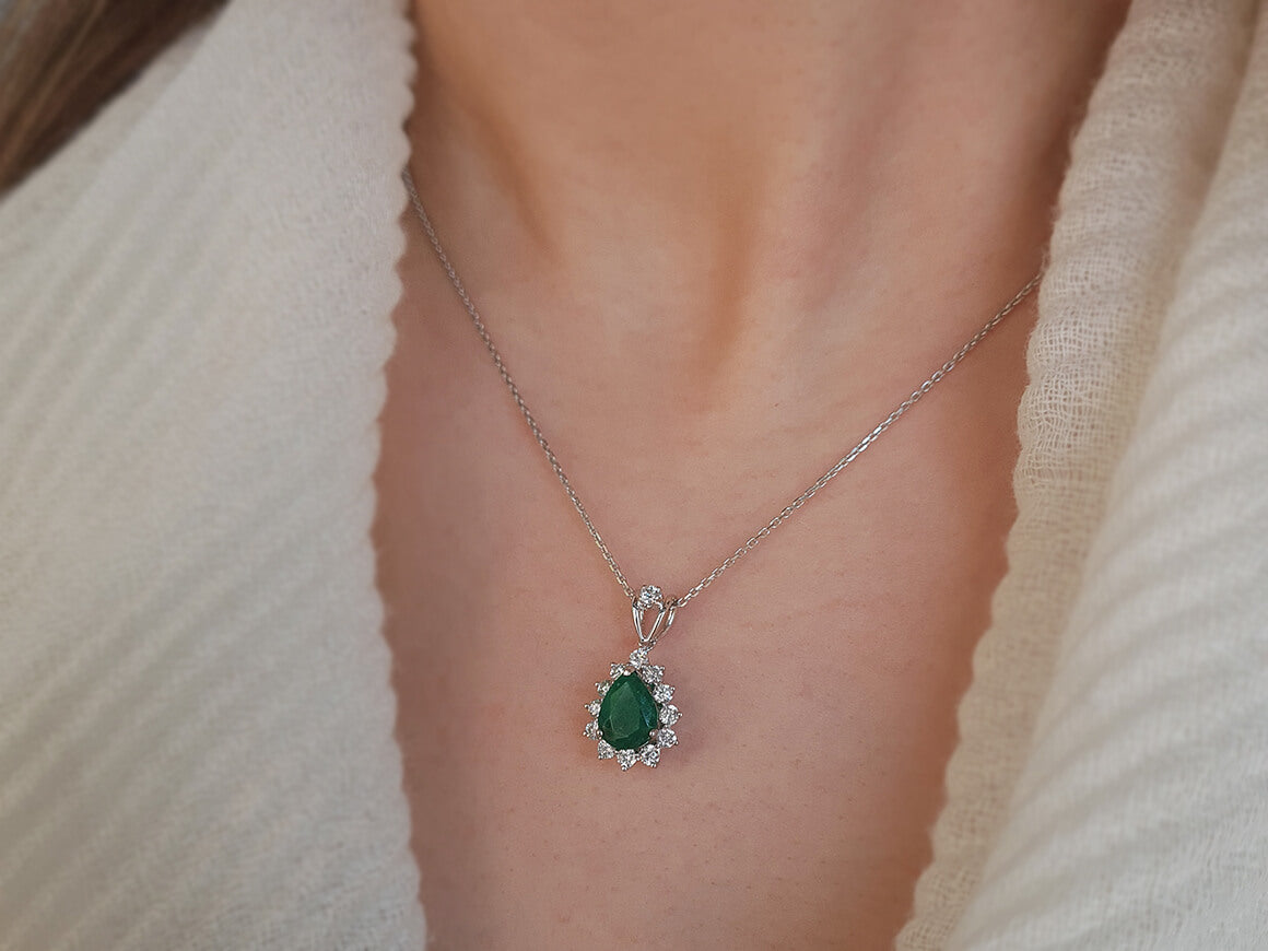 Diamond and drop emerald necklace in 14 carat white gold