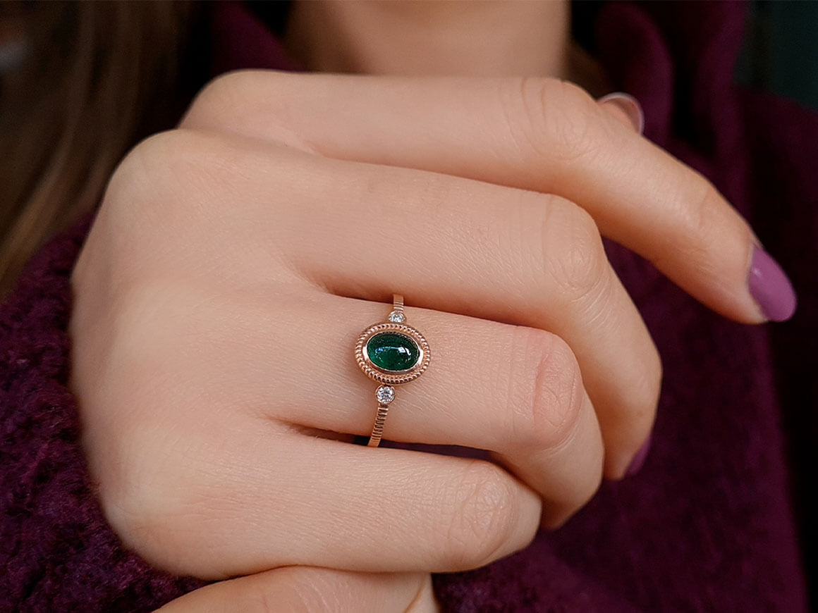 Diamond and cabochon-cut emerald ring