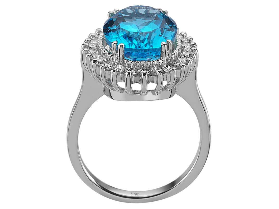 Diamond and oval cut blue topaz ring in 14 carat white gold