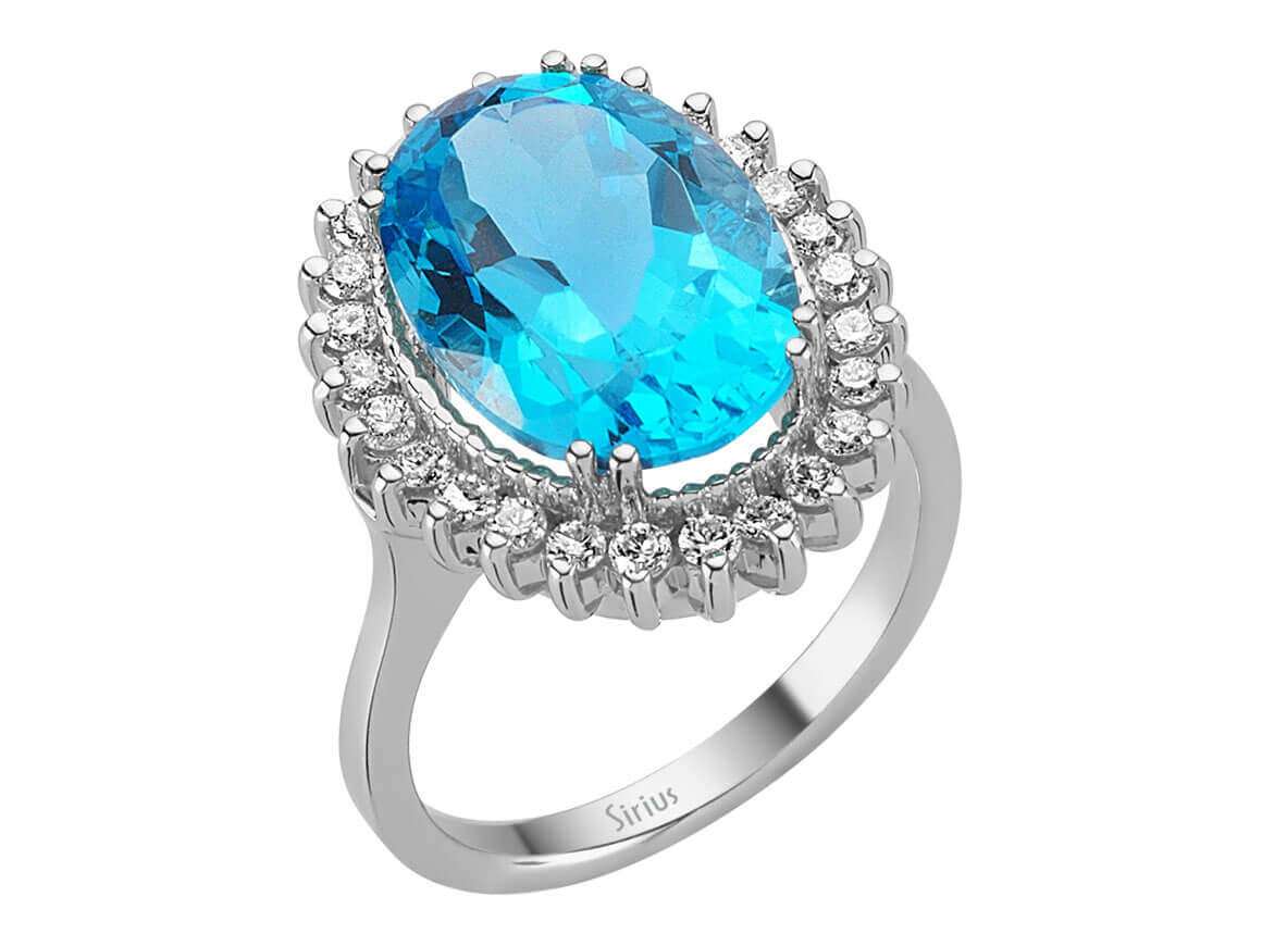 Diamond and oval cut blue topaz ring in 14 carat white gold