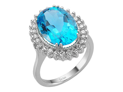 Diamond and oval cut blue topaz ring in 14 carat white gold