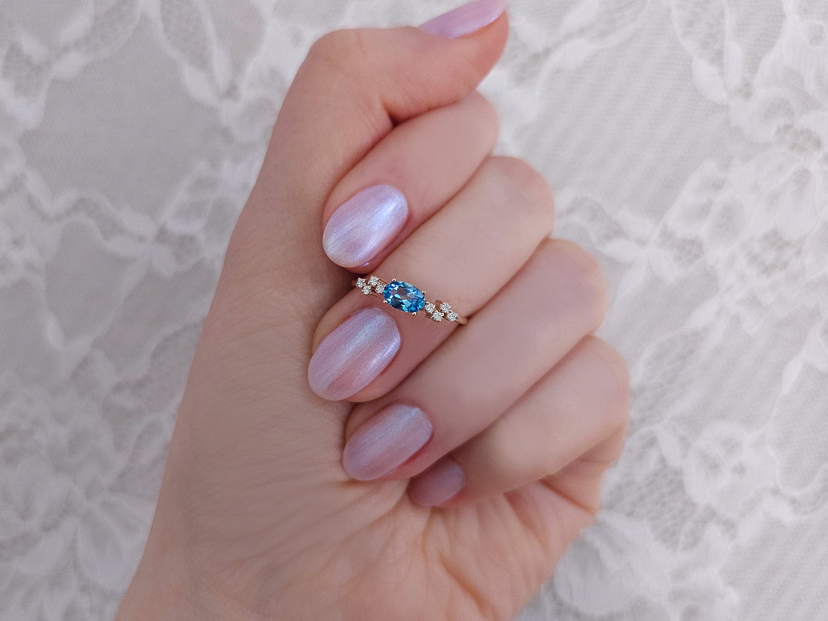 Aquala ring with diamonds and oval blue topaz