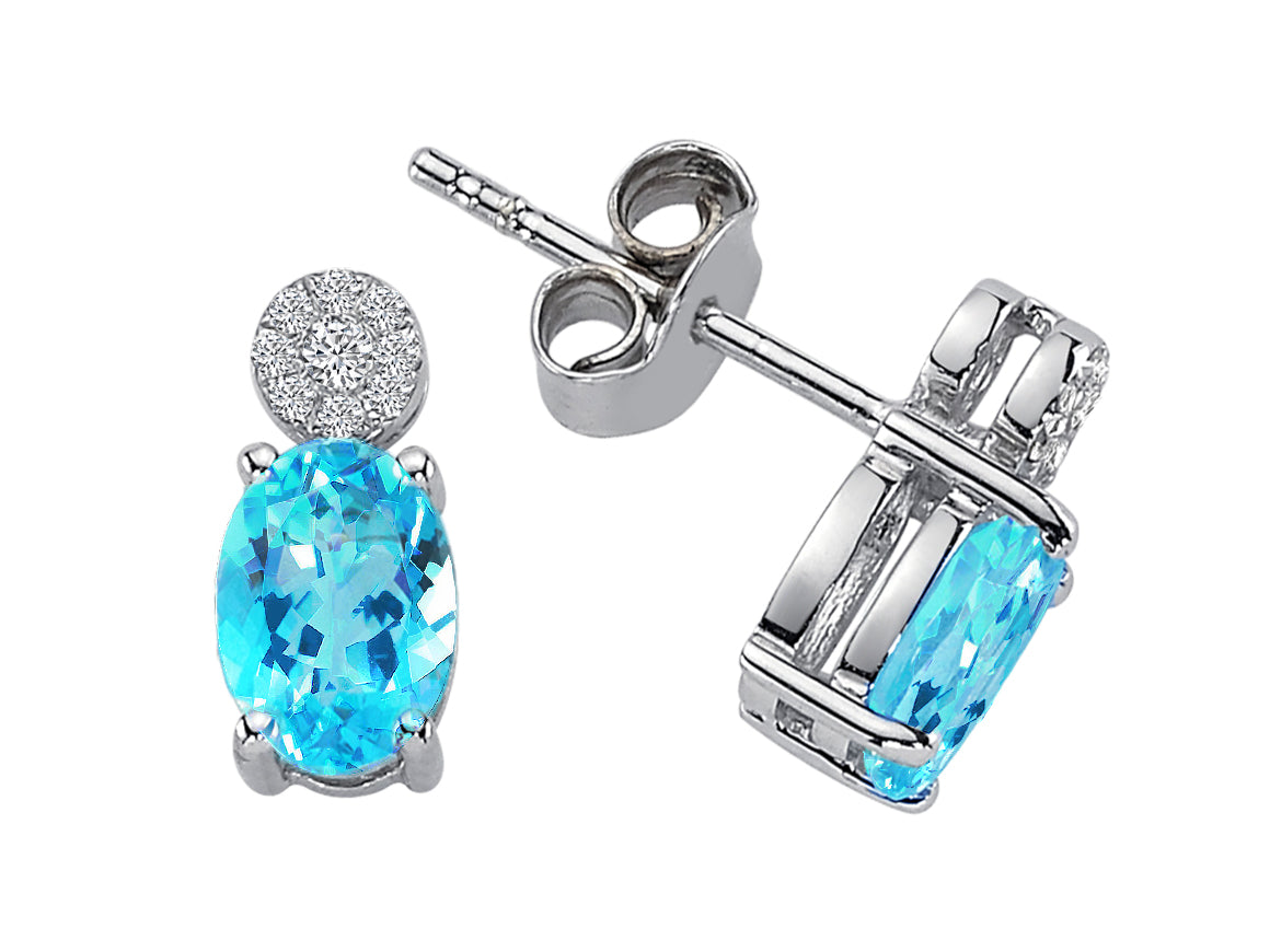 Diamond and oval blue topaz stud earrings in 333 8K gold